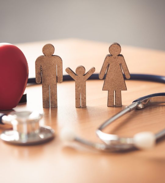 Medical Insurance Concept With Family  And Stethoscope On Wooden Desk