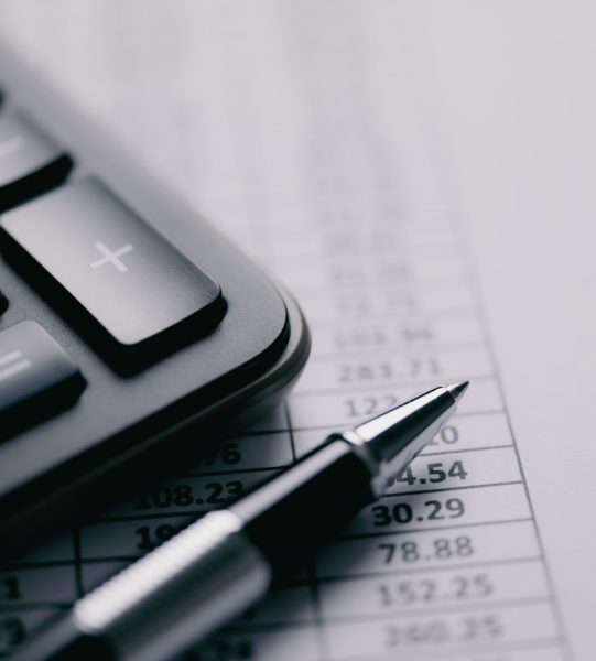 Calculator and stationery items on the table. Accounting concept