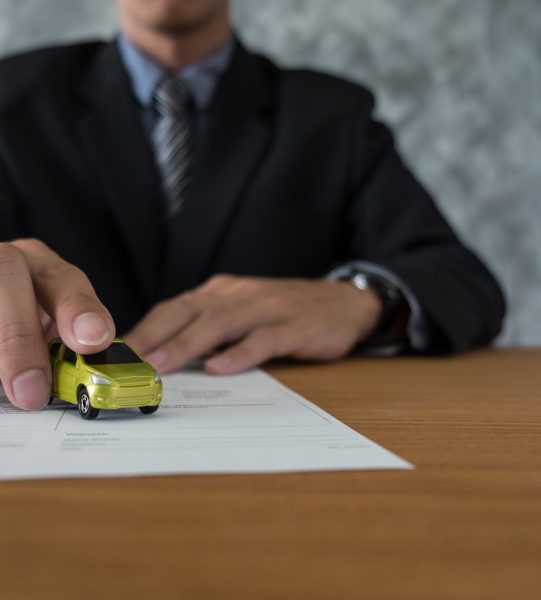 transportation and ownership concept - customer and salesman with car key