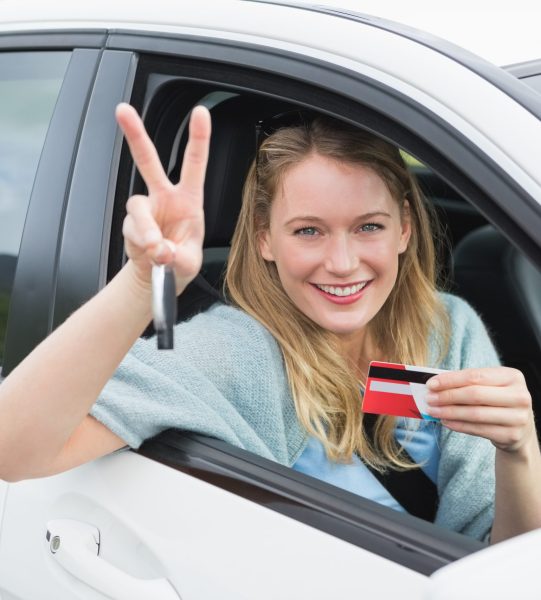young-woman-smiling-holding-card